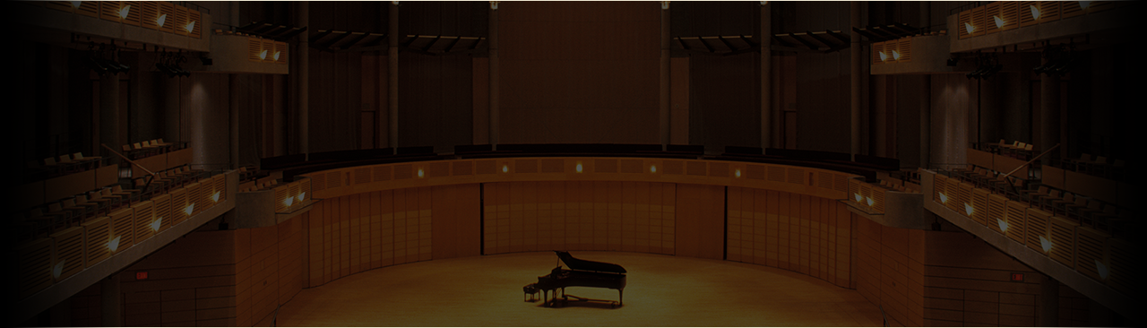 Piano in a darkly tinted concert hall